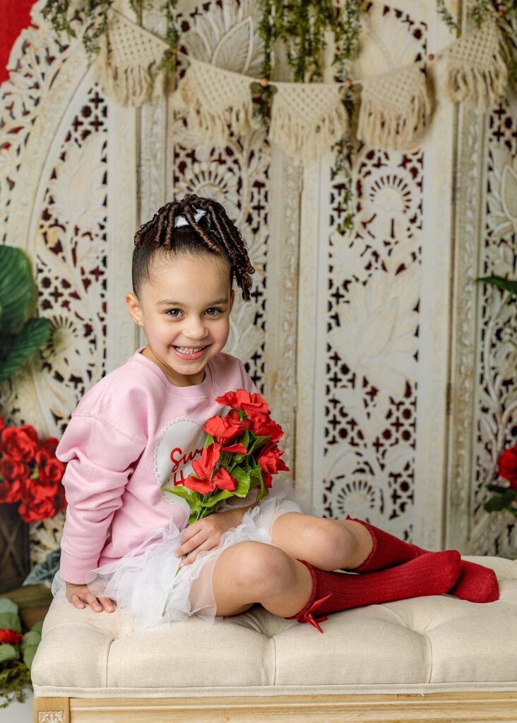a little girl smiling with roses