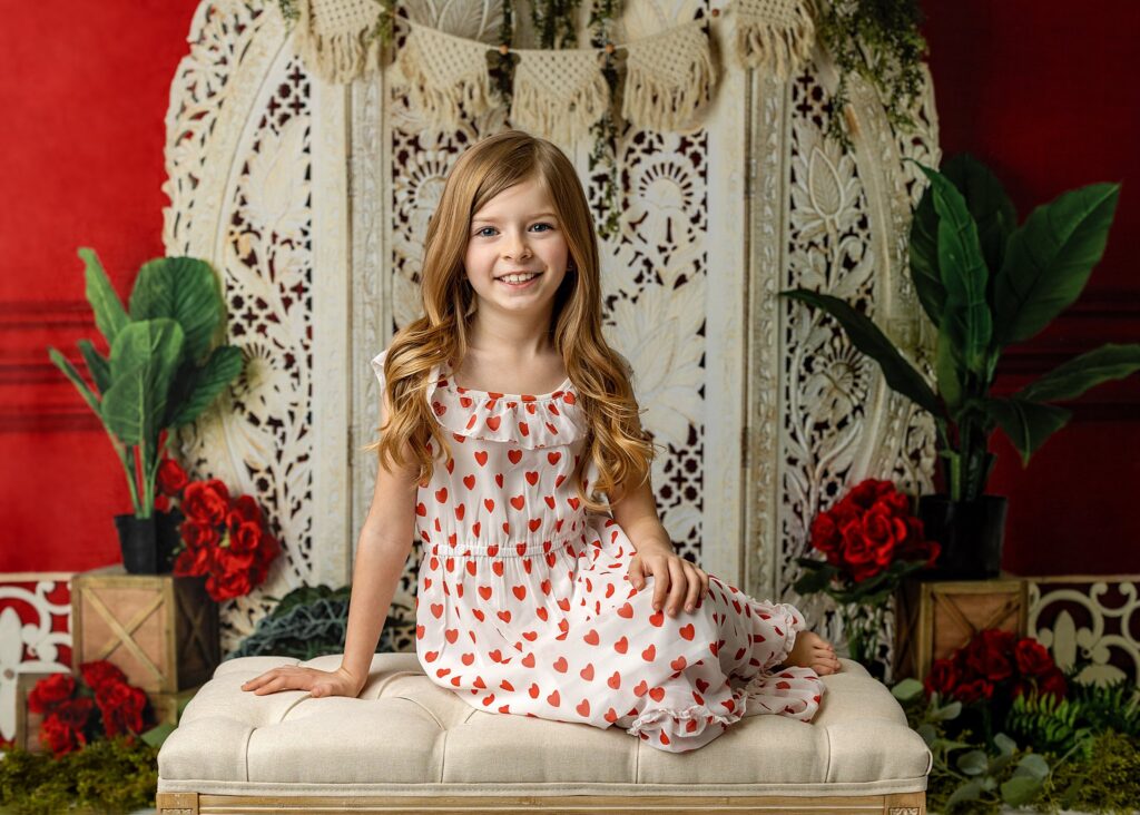 a girl posed on a chair smiling